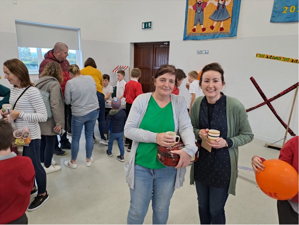 Pupils and parents at a student council bake sale in the school hall