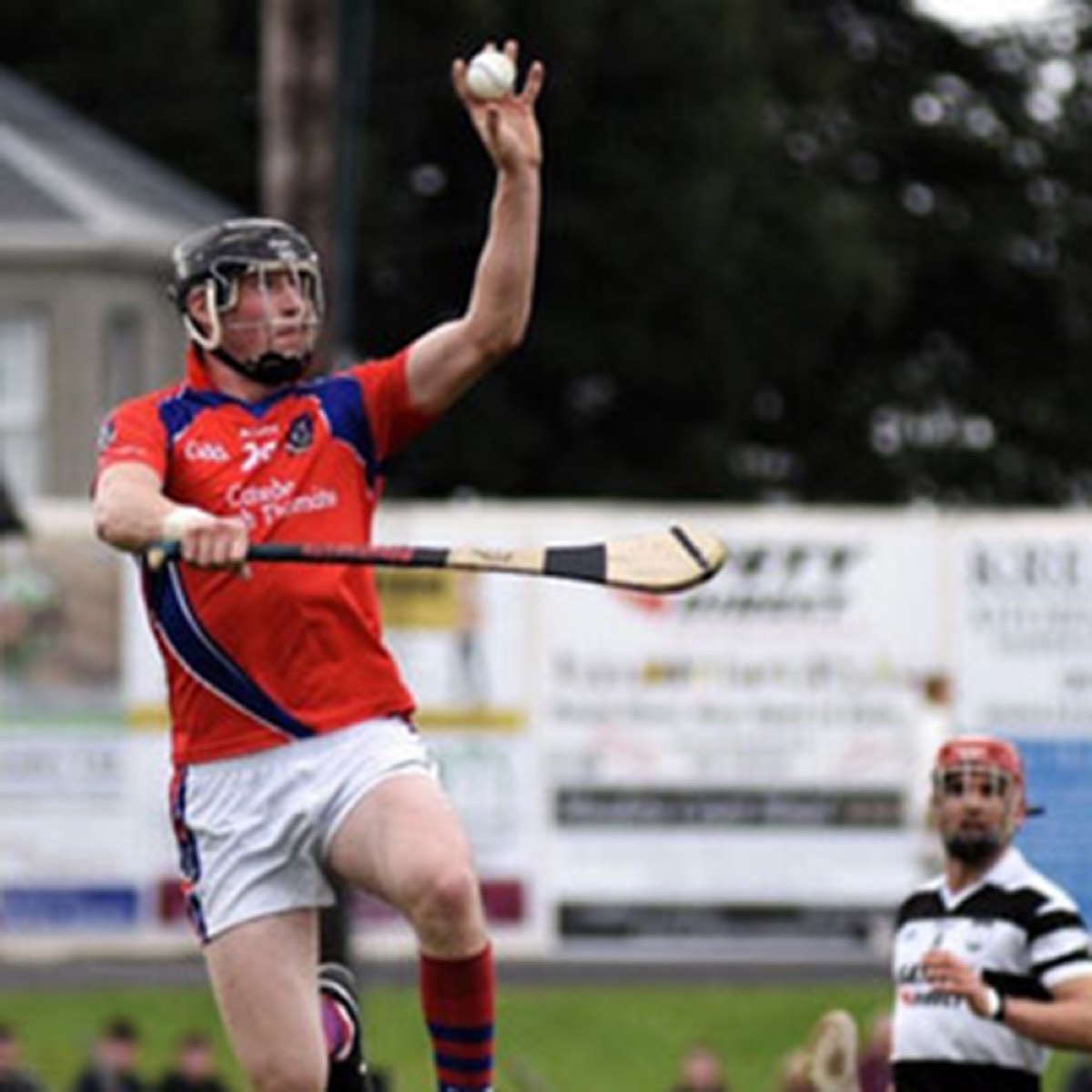 A hurler striking the ball