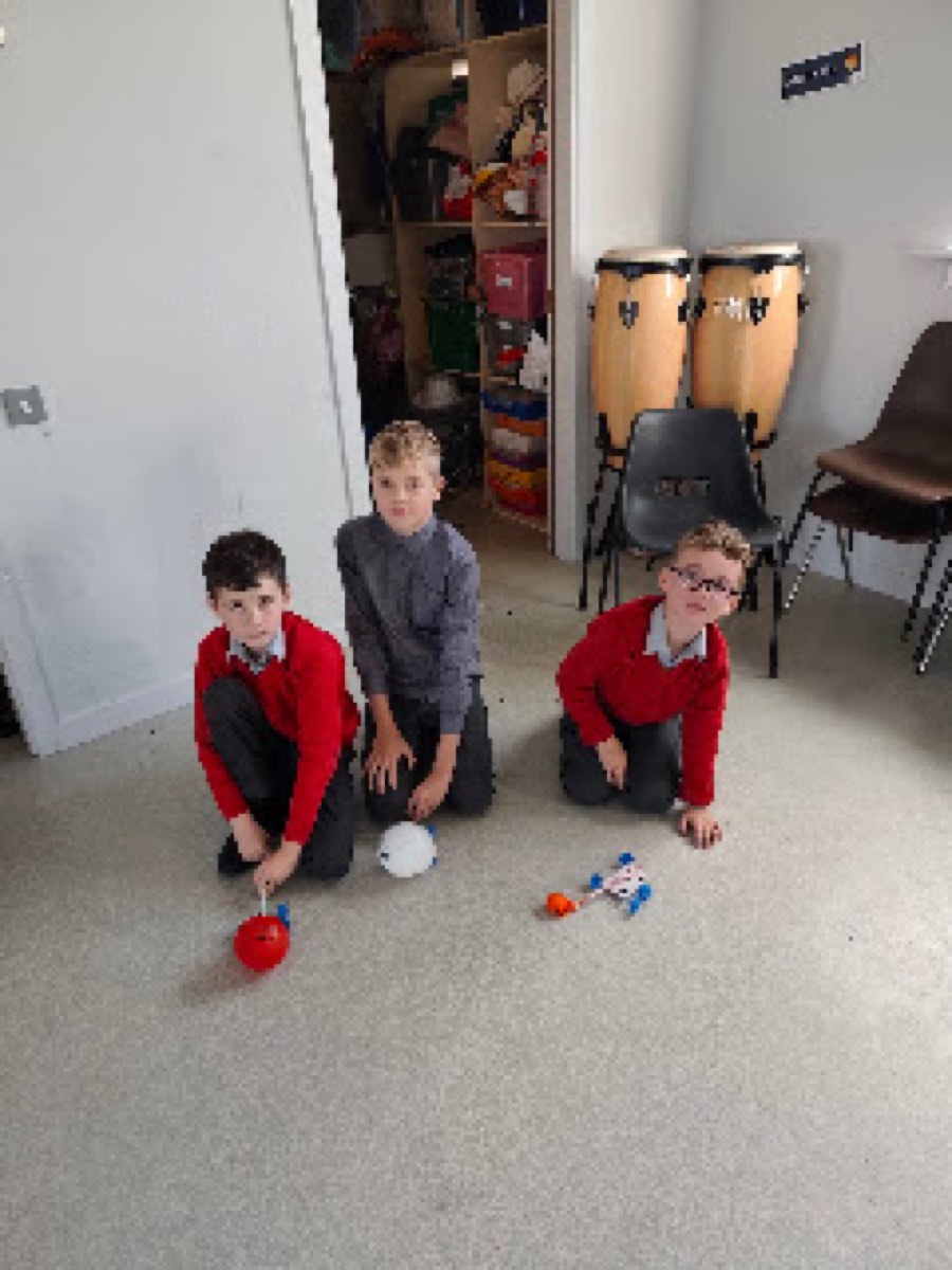 Pupils testing the balloon cars they built in the halla